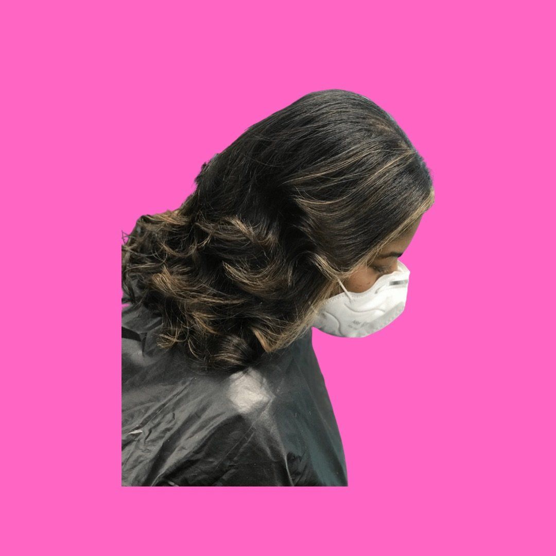 A woman with blonde highlights with a silk press