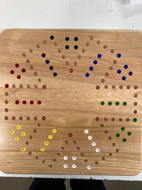 A wooden board with colored dots on it