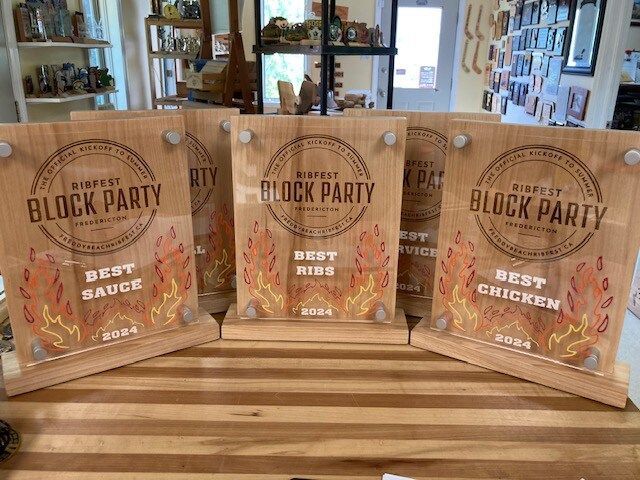 A group of wooden plaques sitting on top of a wooden table.