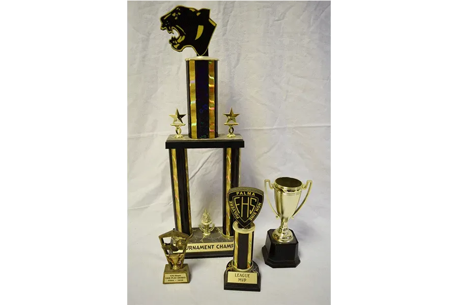 A group of trophies are stacked on top of each other