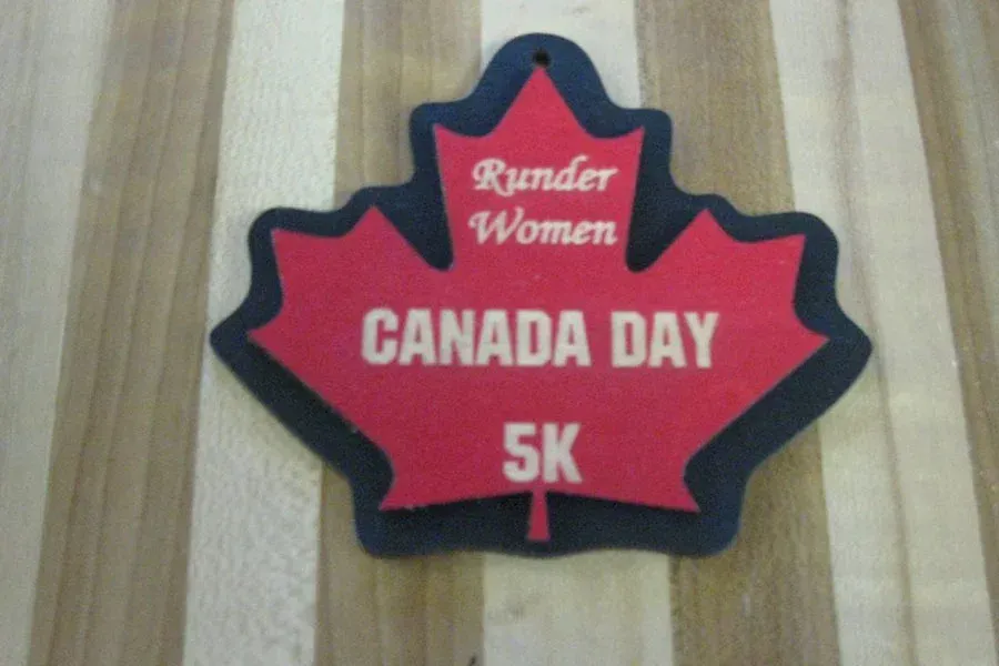 A red maple leaf shaped medal for canada day 5k