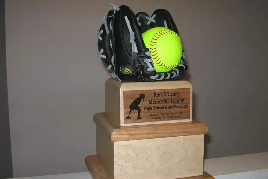 A trophy with a softball and a baseball glove on it