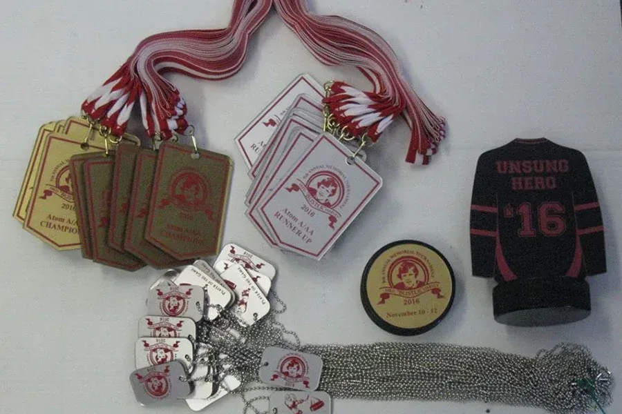 A collection of medals and badges including one with the number 16 on it