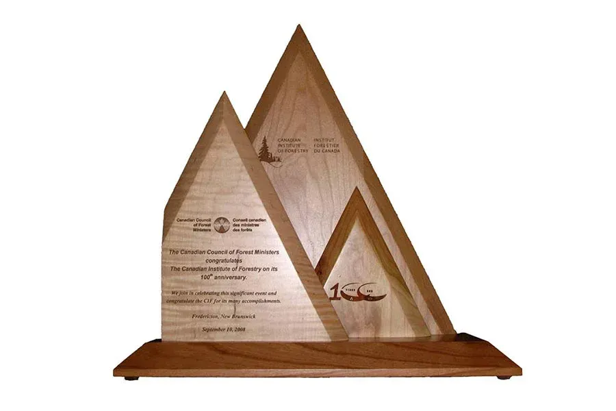 A wooden plaque in the shape of a mountain