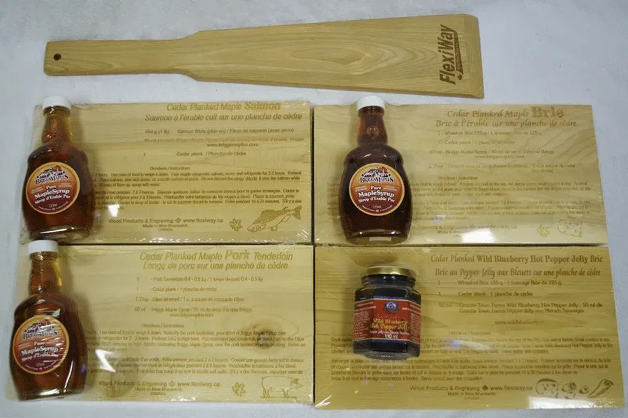 Four bottles of maple syrup and a wooden spatula