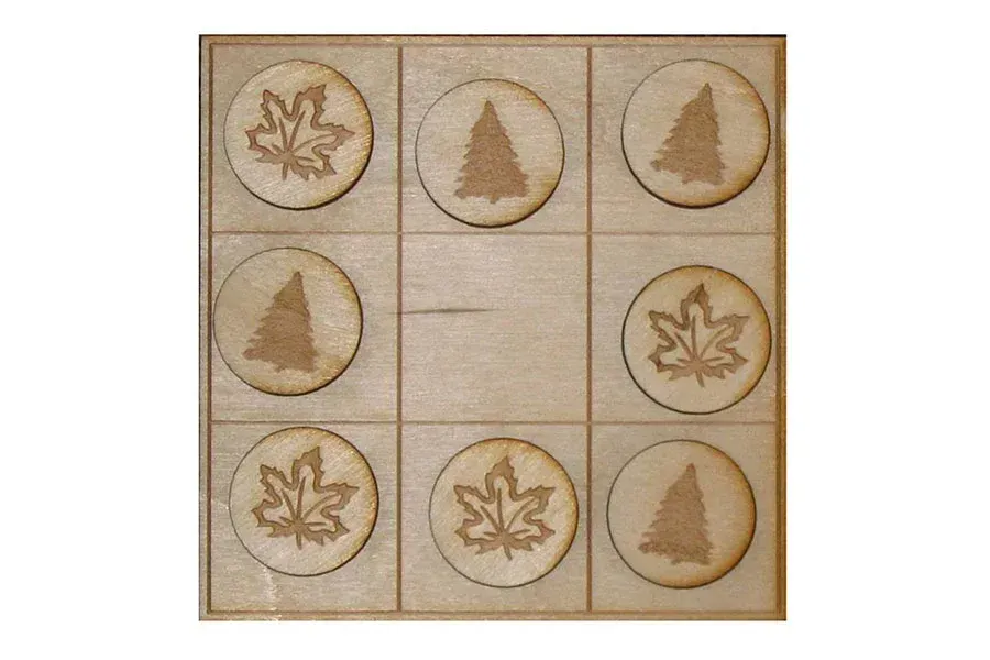 A wooden tic tac toe board with trees and leaves on it