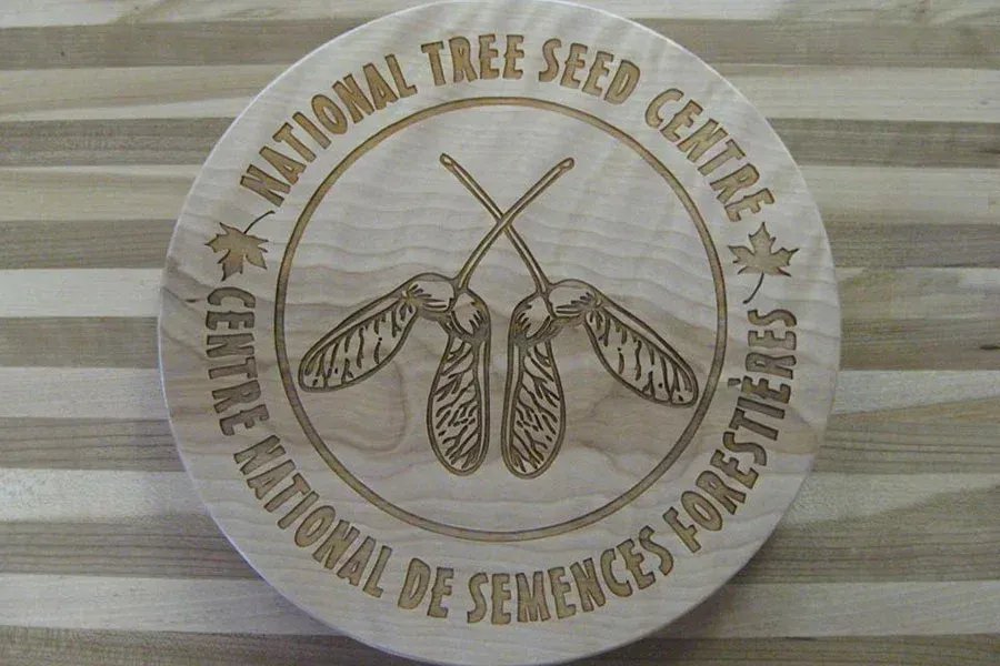 A round wooden sign that says national tree seed centre