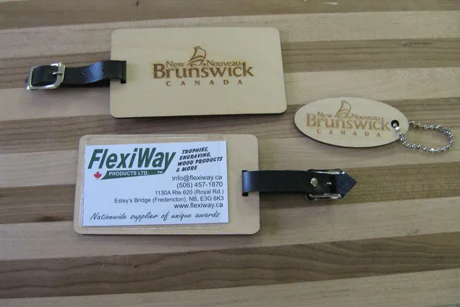A wooden luggage tag with brunswick canada written on it