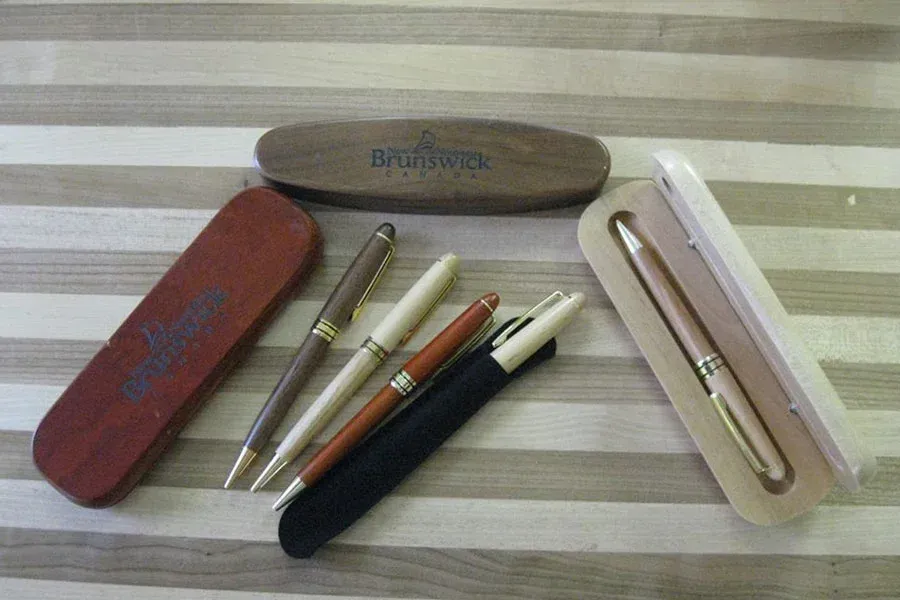 A wooden pen case with the word brother on it