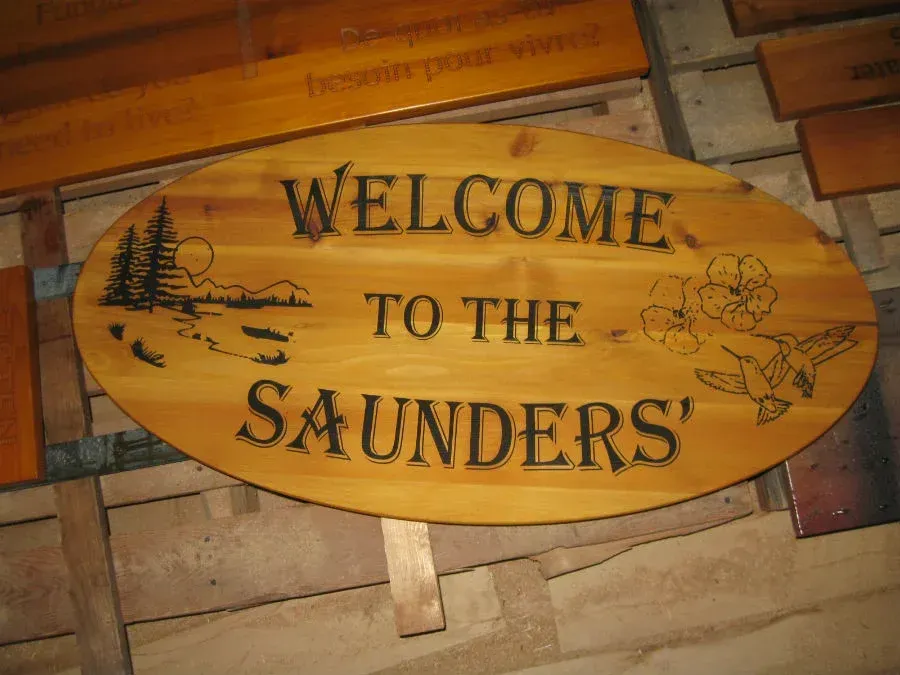 A wooden sign that says welcome to the saunders