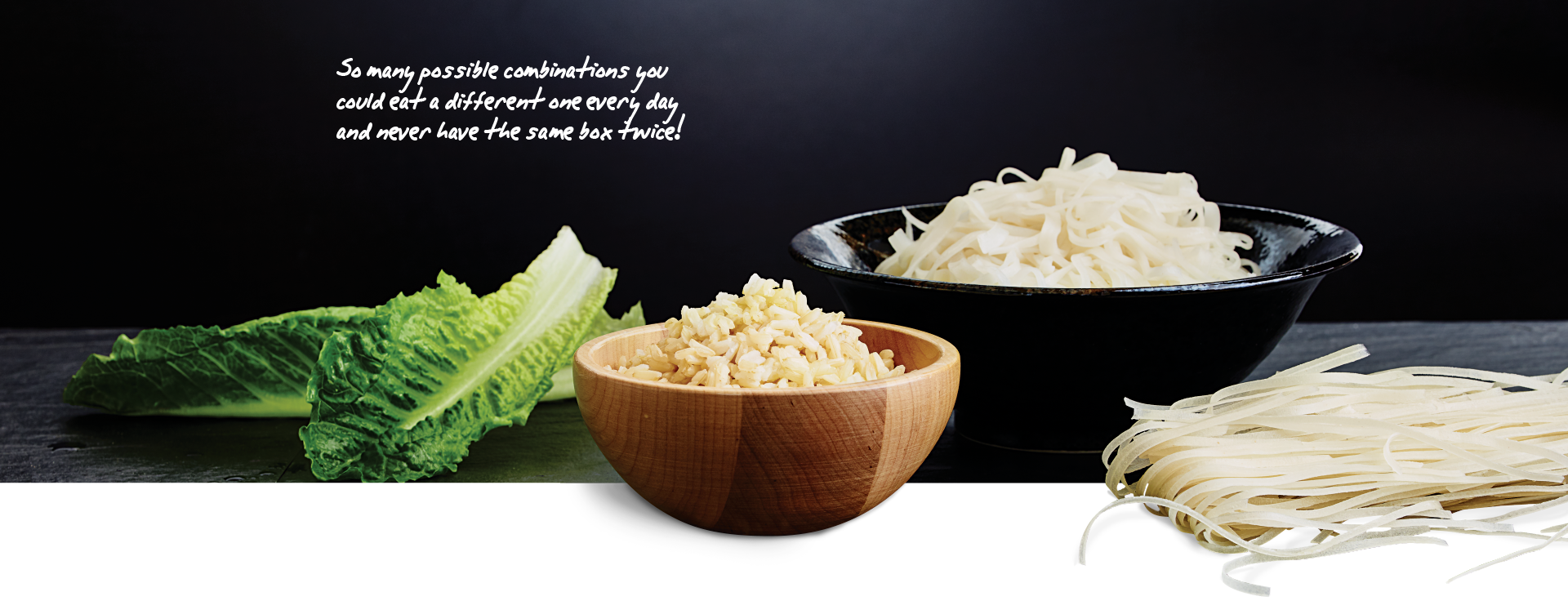 A bowl of rice and a bowl of noodles are on a table.