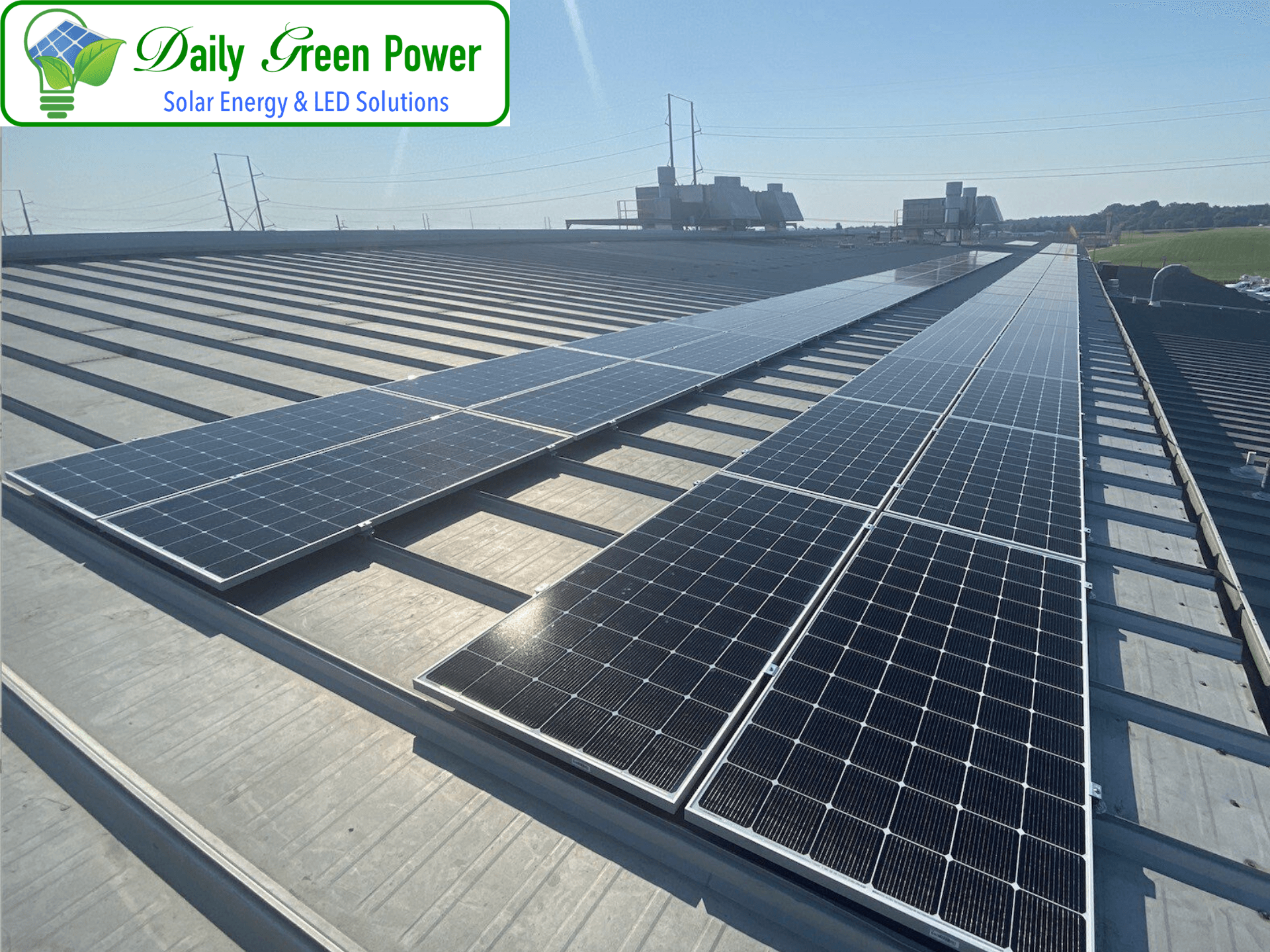 A row of solar panels on the roof of a building