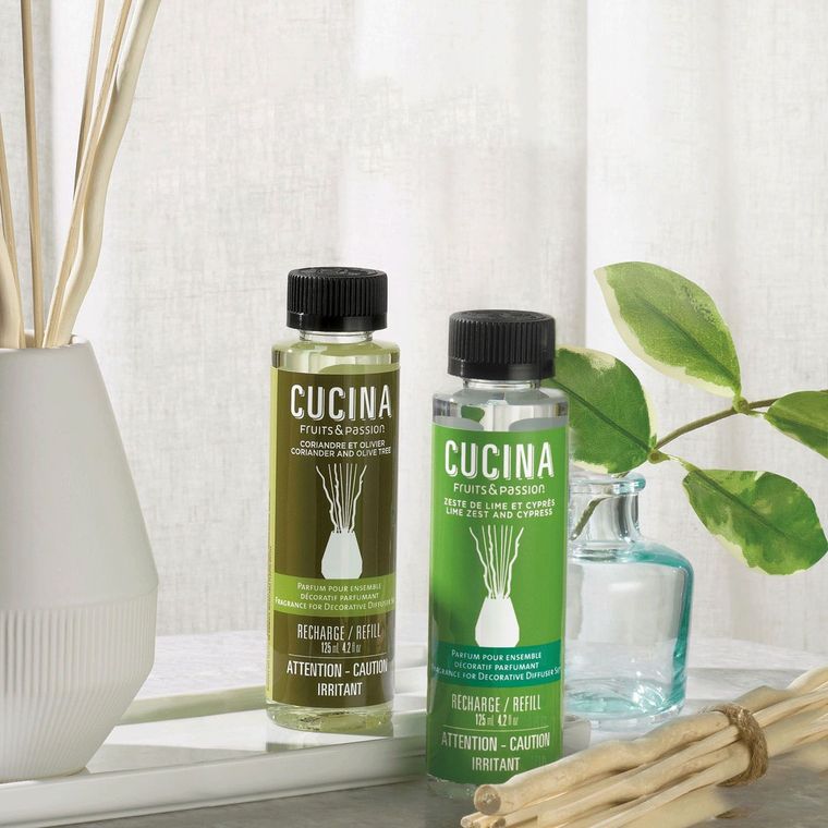 Two bottles of cucina sitting next to each other on a table