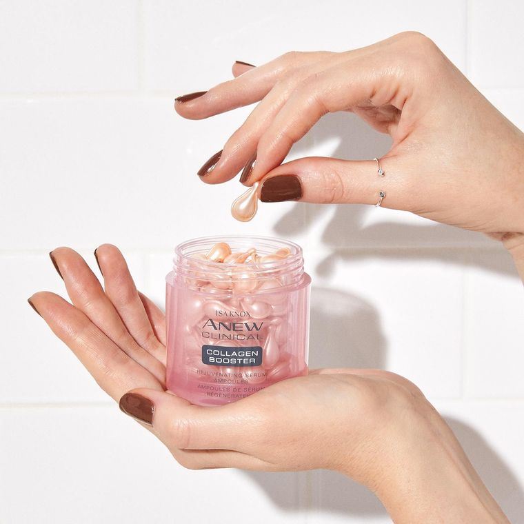 A woman is holding a jar of anew vitamins in her hands.