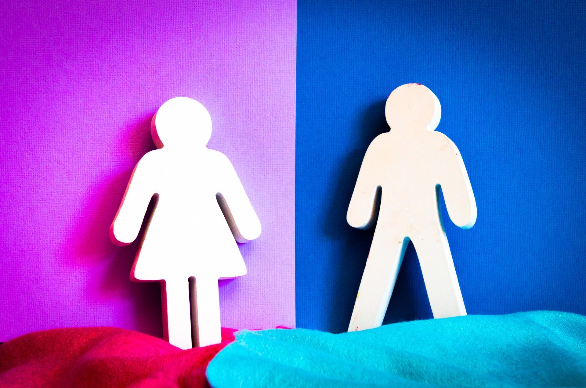 Silhouette figures of woman and man against purple/blue background.
