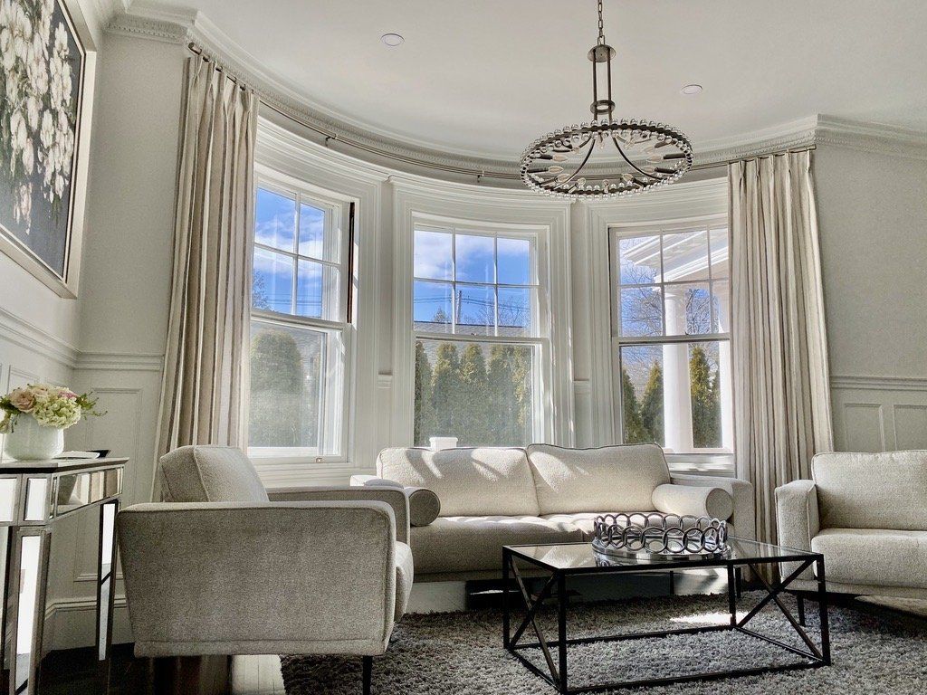 a living room with a couch , chairs , and a coffee table Simply Windows.