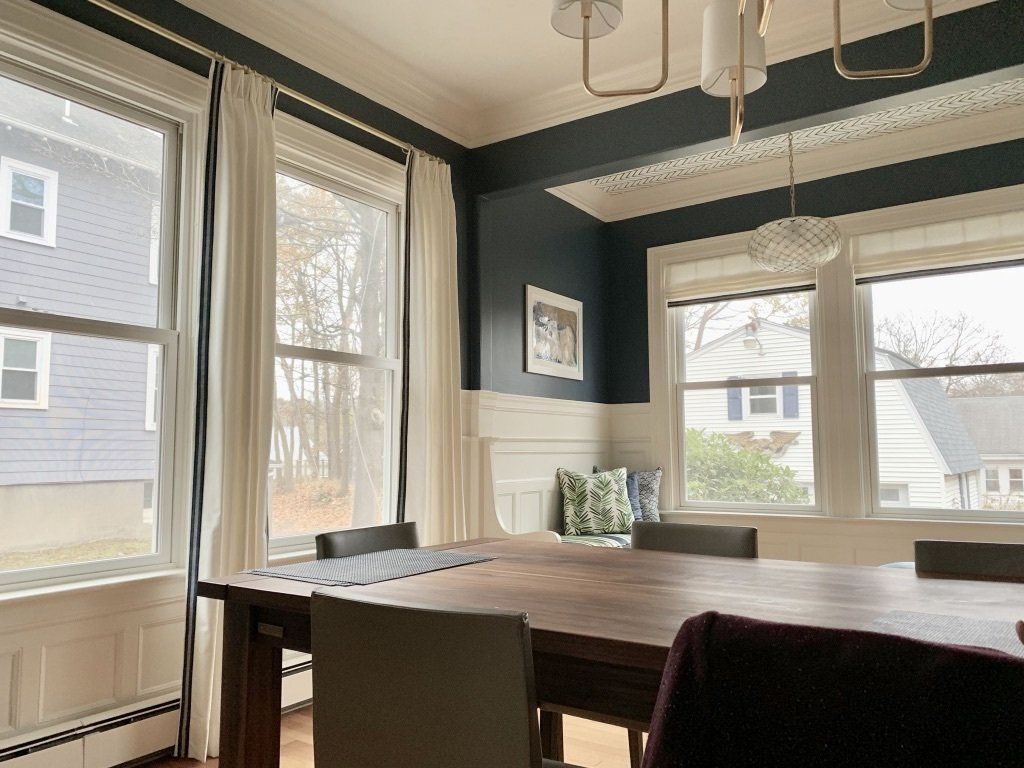 a dining room with a table and chairs and lots of windows Simply Windows