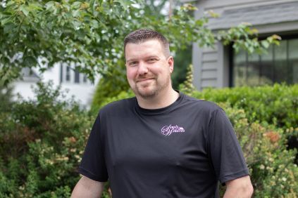 a man in a black shirt is standing in front of a bush Bobby Hackett Simply Windows.