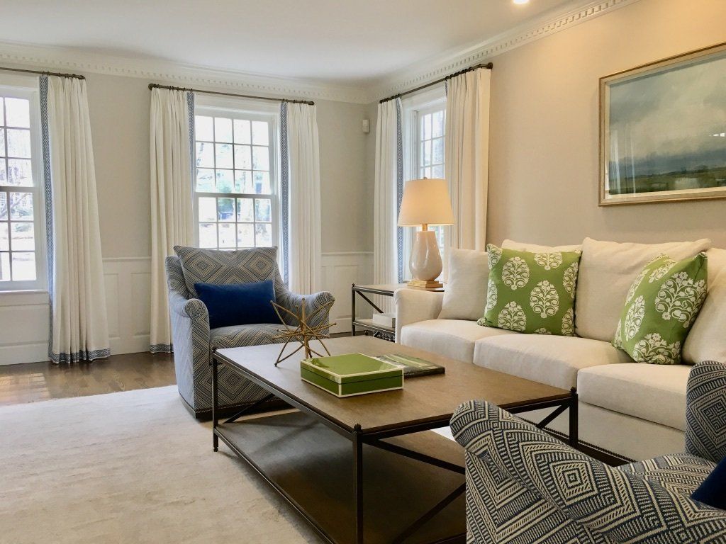 a living room with a couch and chairs and a coffee table Simply Windows