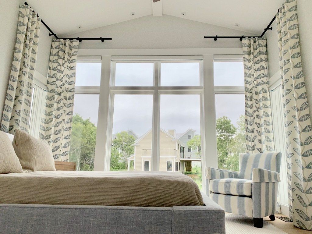 a bedroom with a bed , chair , and lots of windows Simply Windows.
