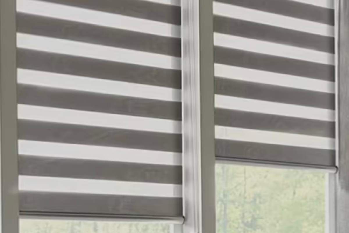a pair of gray and white striped sheer shadings on a window Simply Windows.