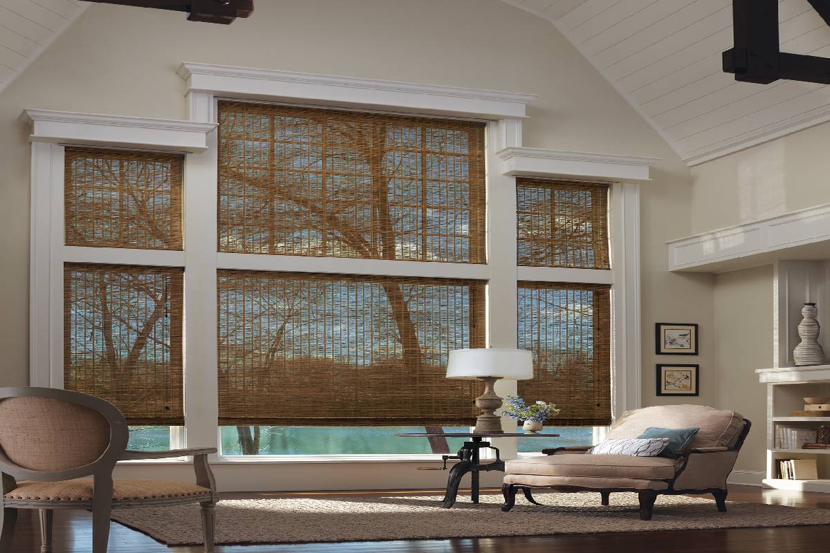 a living room with a vaulted ceiling and custom woven wood shades on the windows Simply Windows.