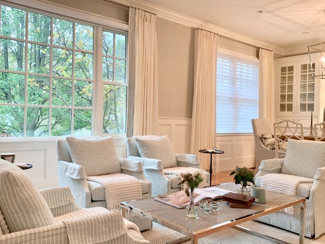 a living room filled with furniture and a coffee table with custom drapery Simply Windows.