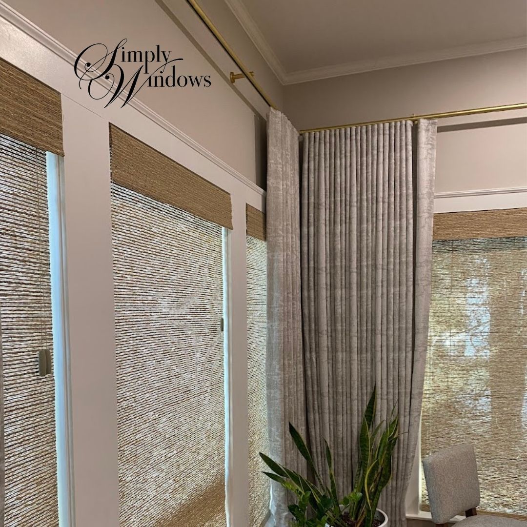 Interior window with layered blinds and curtains, gold trim, and a house plant.
