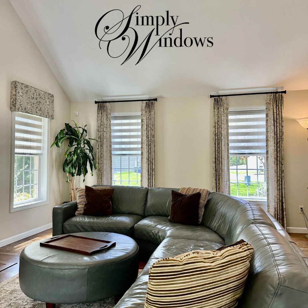 Living room with gray sectional sofa, zebra blinds, and valance; Simply Windows logo.
