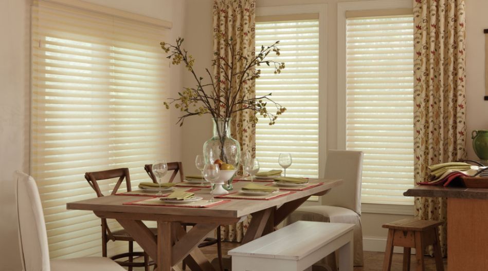 An elegant dining room spotlights Lafayette fabric drapes in a beige floral pattern.