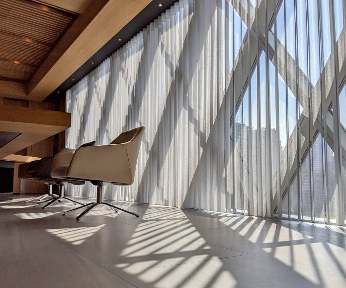 A dining room features Norman SmartDrapes on the sliding glass doors. 