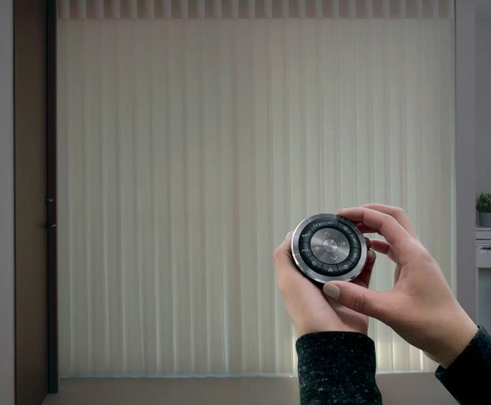 A smart home control device is shown against the backdrop of SmartDrapes. 