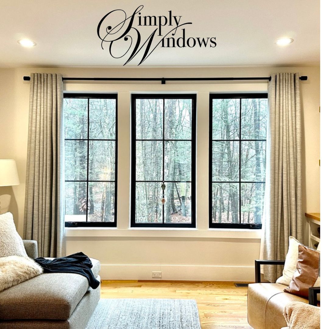 A cozy living room has elegant drapery on the window - simply windows, ma
