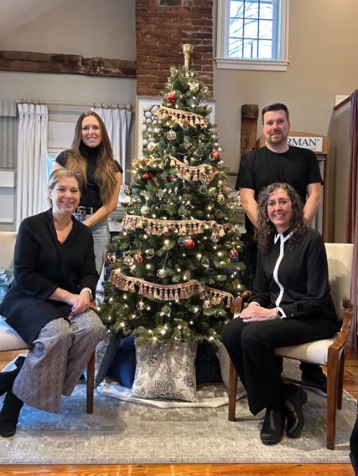 the Simply Windows team are posing for a picture in front of a christmas tree