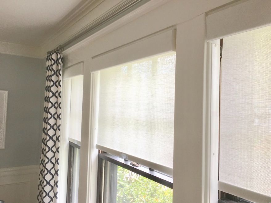 Simply Windows: A window with white motorized roller blinds and curtains on it