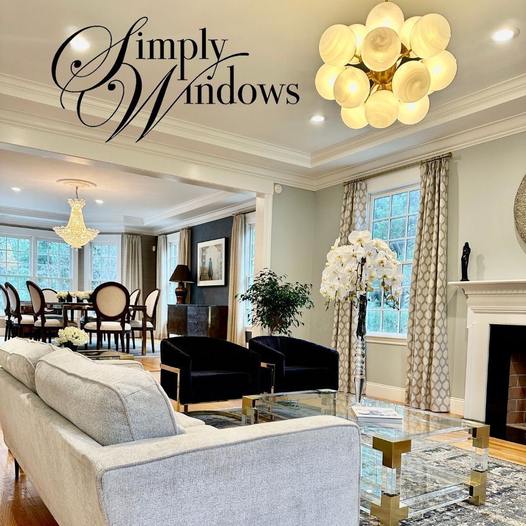An elegant livvng room with glass chandeliers have custom drapery -simply-windows-ma