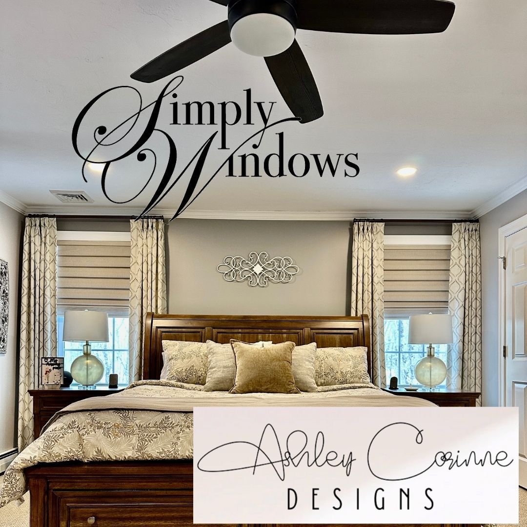 A bedroom featuring a wooden bed, patterned curtains, roman shades, and bedside lamps with a ceiling fan above.