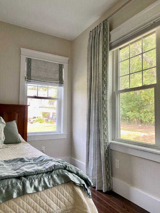 Simply Windows: A bedroom with a bed , window and Roman shades.
