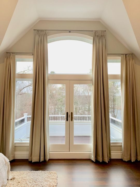 Simply Windows: A room with a large window with beige drapes and sliding glass doors leading to a balcony.