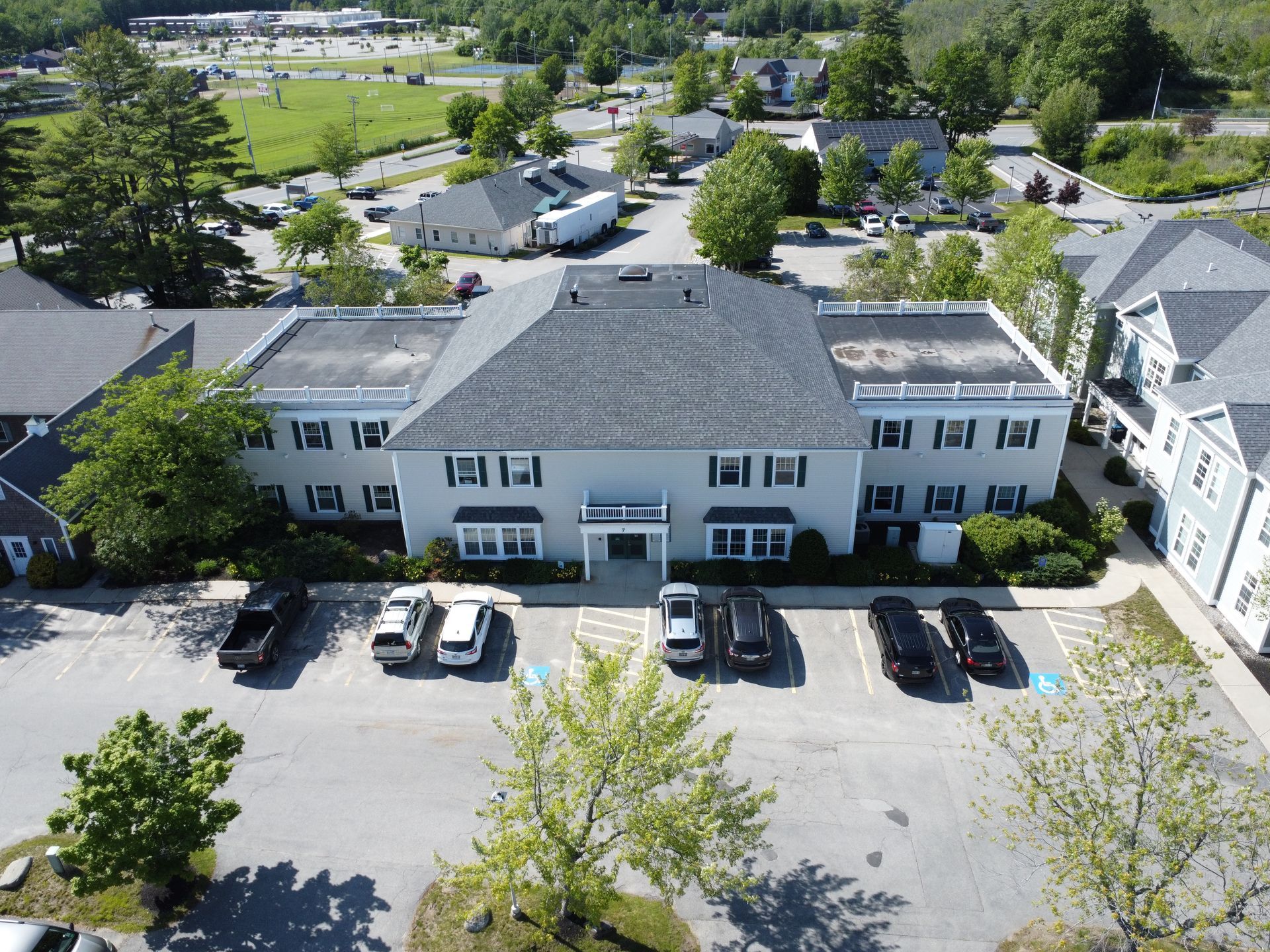 an aerial view of a building with cars parked in front of it