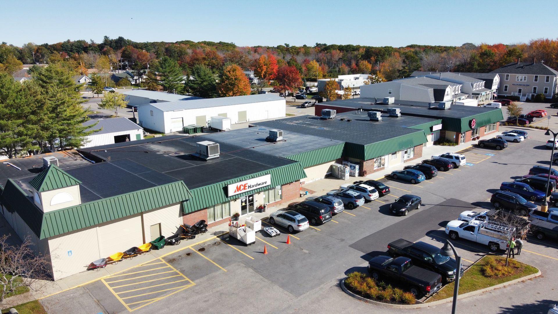 an aerial view of a shopping center with a lot of cars parked in front of it .