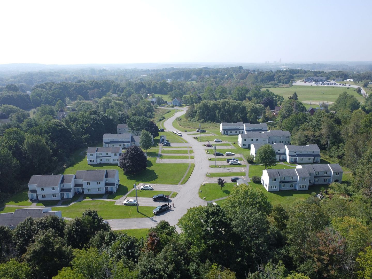 an aerial view of a residential area with houses and trees