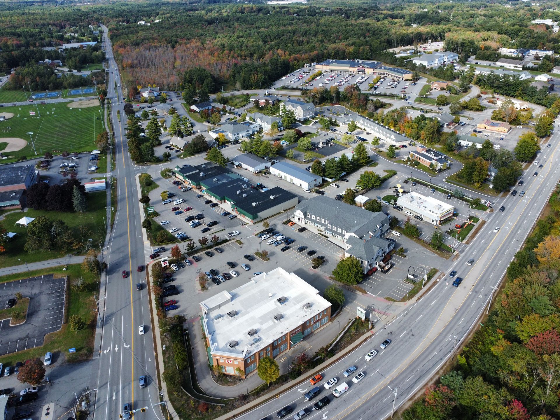 an aerial view of a city with a lot of buildings and a highway .