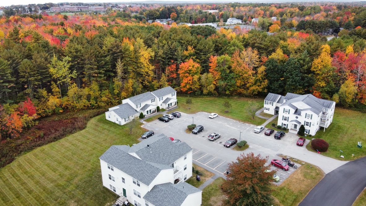 an aerial view of a apartment complex in the middle of a forest .