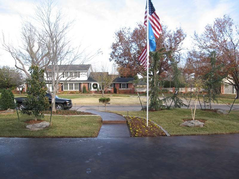 An american flag is flying in front of a house
