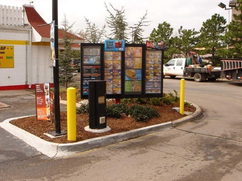 A mcdonald 's drive thru with a sign that says ' ice cream ' on it