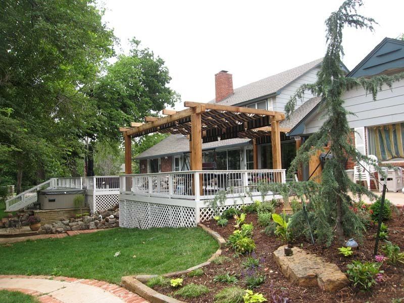 A house with a large deck and a pergola