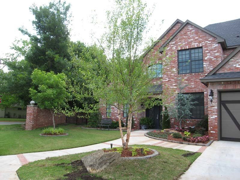 A brick house with a tree in front of it