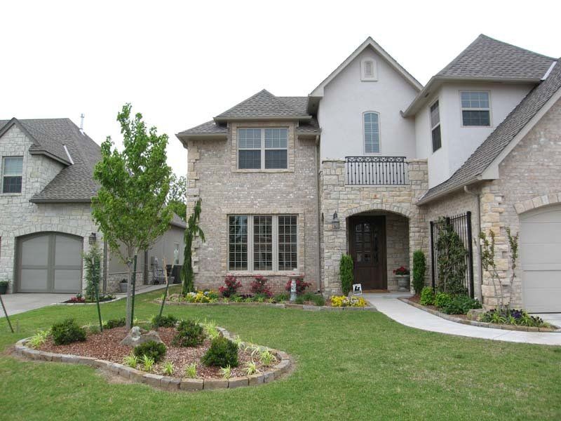 A large house with a lush green lawn in front of it
