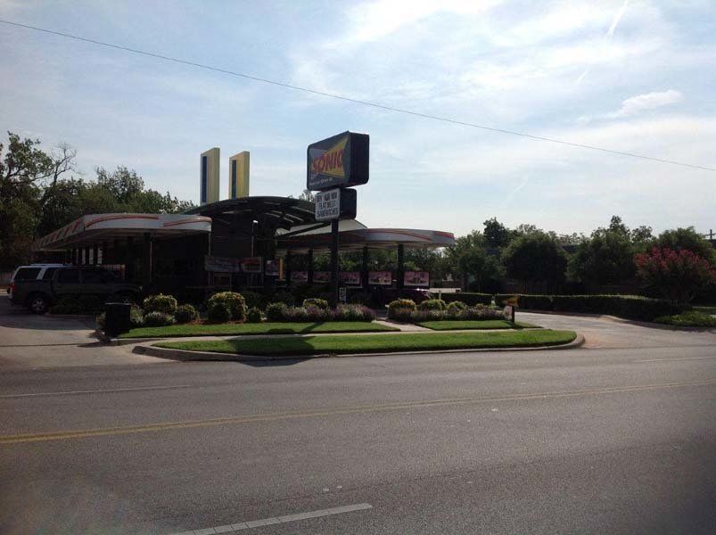 A Burger King restaurant is located on the side of the road